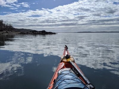 a person standing next to a body of water
