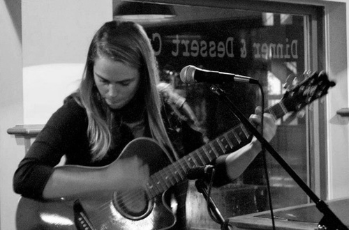 a woman holding a guitar