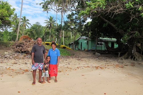 a group of people standing on top of a sandy beach