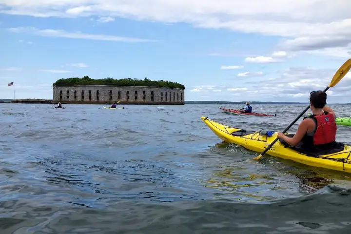 Kayakers approaching Fort Gorges on Casco Bay in Portland, Maine