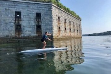 a person standing next to a body of water