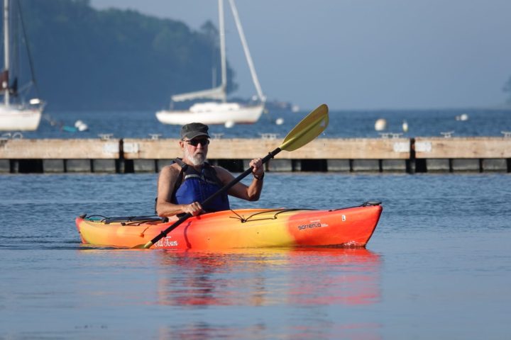 Man kayaking at the East End Beach in Portland, Maine