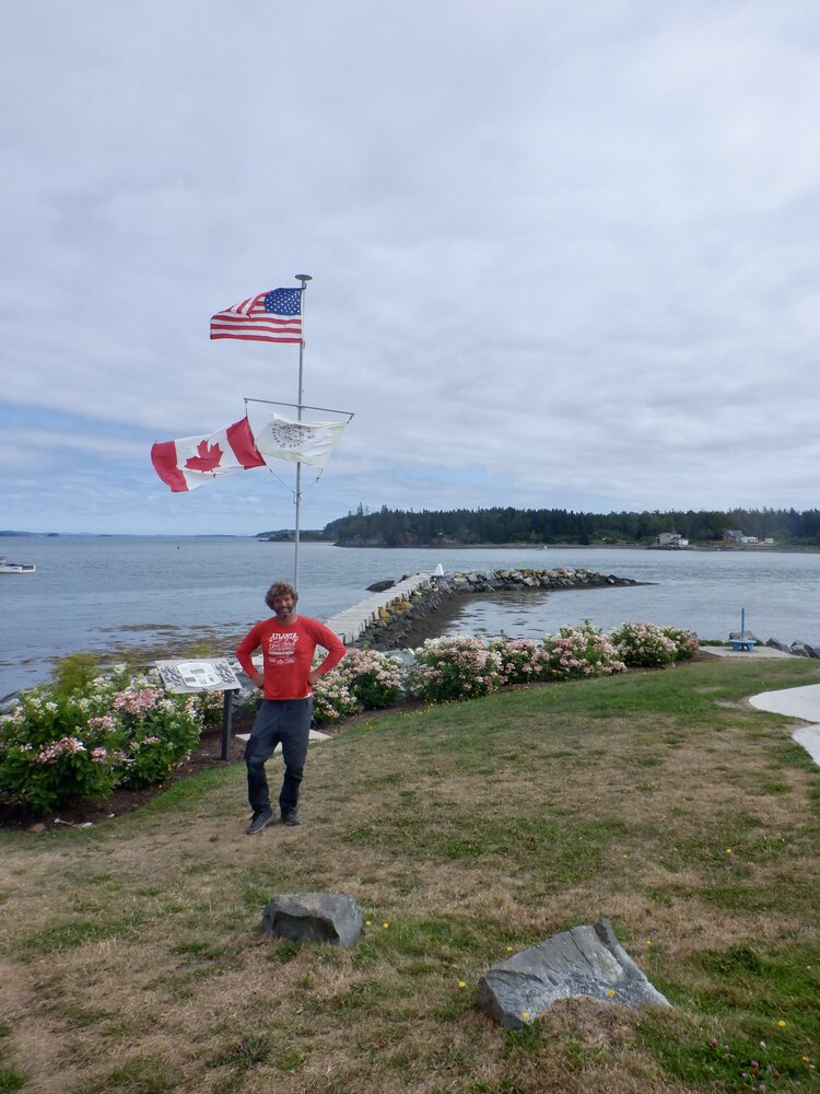 a person flying a kite in a large body of water