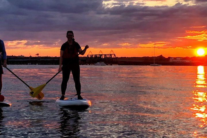 a person standing next to a body of water