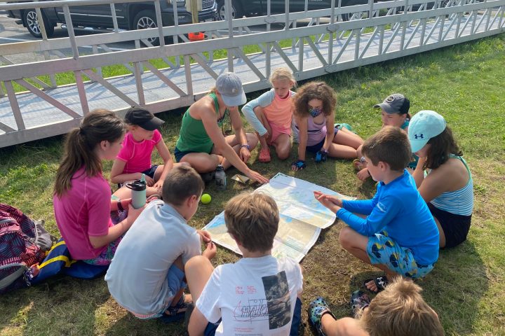 a group of people sitting at a zoo