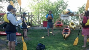 a group of people playing frisbee in a yard