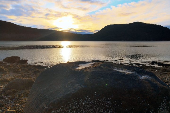 a body of water with a mountain in the background