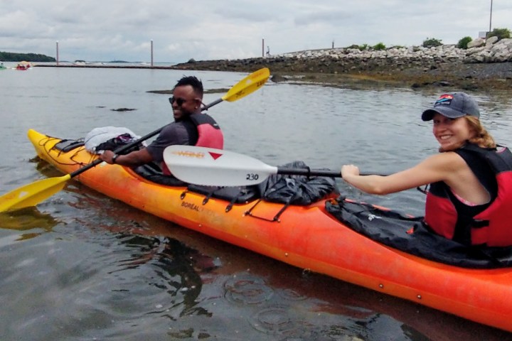 a group of people rowing a boat in the water