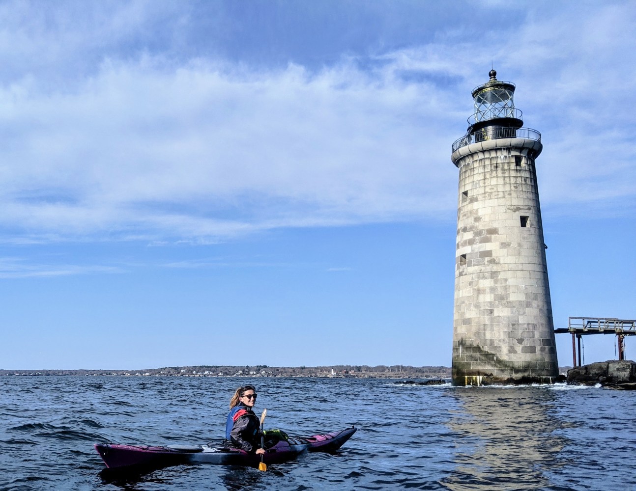 a man riding on the back of a boat in a body of water