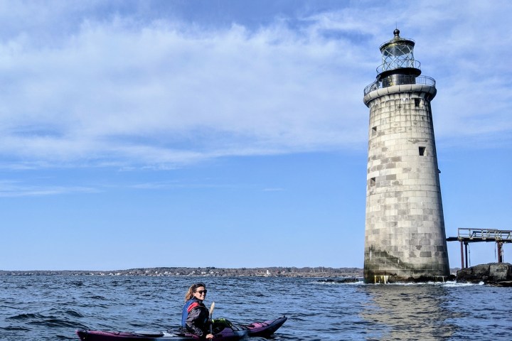 Sea kayaking to lighthouse on coast of Maine
