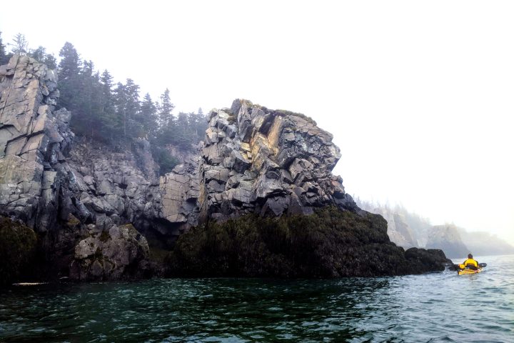 a large body of water with a mountain in the background