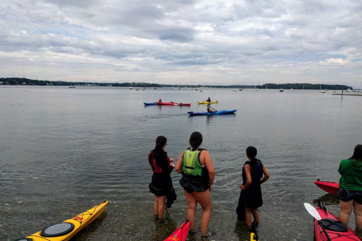 a group of people in a boat on a body of water