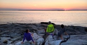 Watching the sunset over the rocky coast of the Penobscot Acadia Downeast region