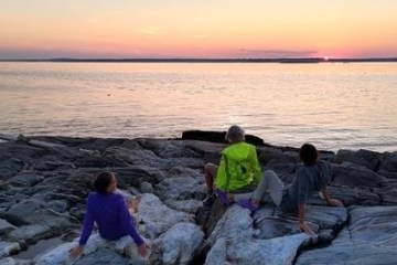 Watching the sunset over the rocky coast of the Penobscot Acadia Downeast region