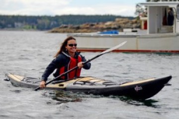 a person riding on the back of a boat in the water