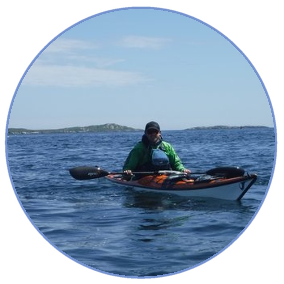 a man riding on the back of a boat in the water