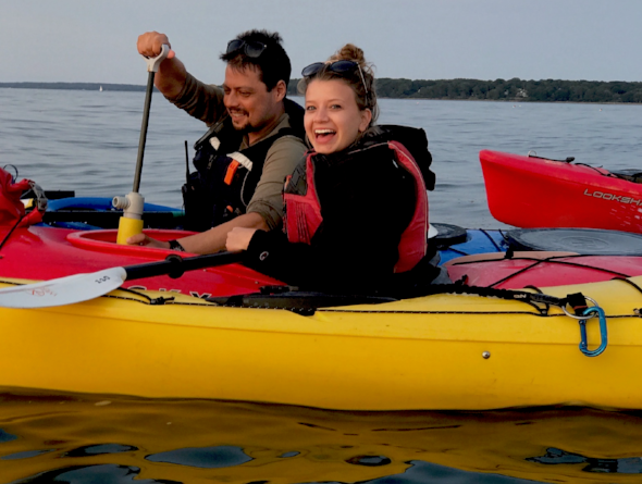 a group of people in a boat on a body of water
