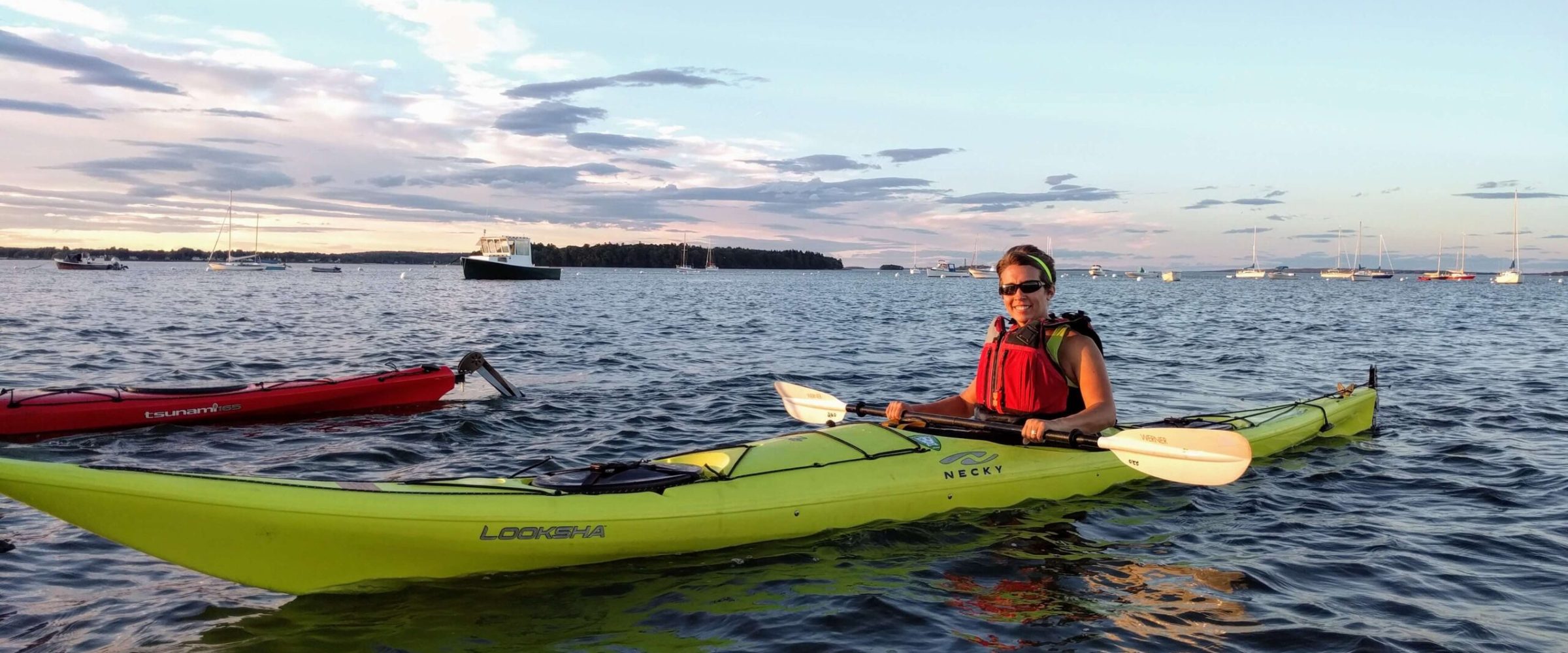a man riding on the back of a boat in the water