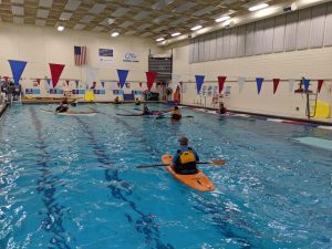 Whitewater and Sea Kayaks practicing in the pool