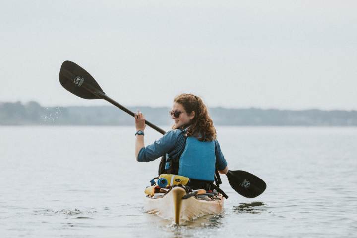 a person riding a surf board on a body of water
