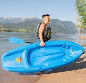 a child in a blue boat on a body of water