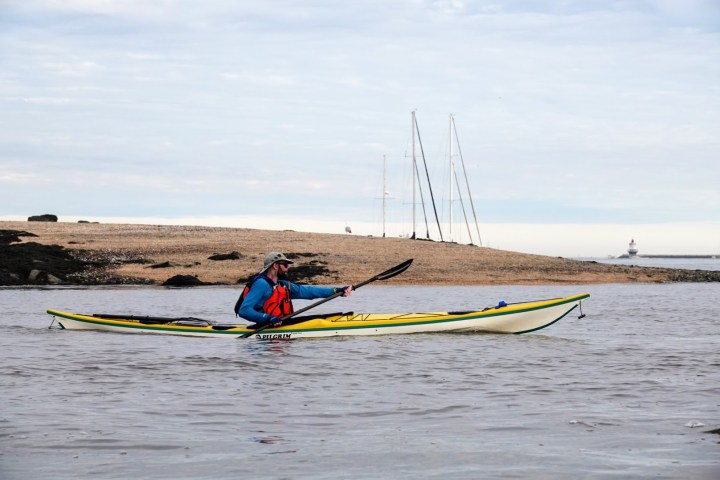 a man rowing a boat in a body of water