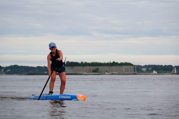 a person riding a surf board on a body of water
