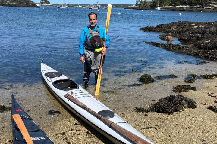 a boat sitting on top of a sandy beach
