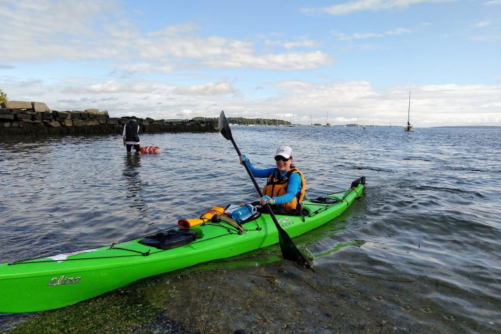 a group of people in a boat on a body of water