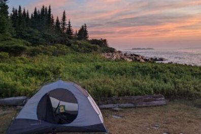 A tent beside the ocean during a Maine sea kayak trip