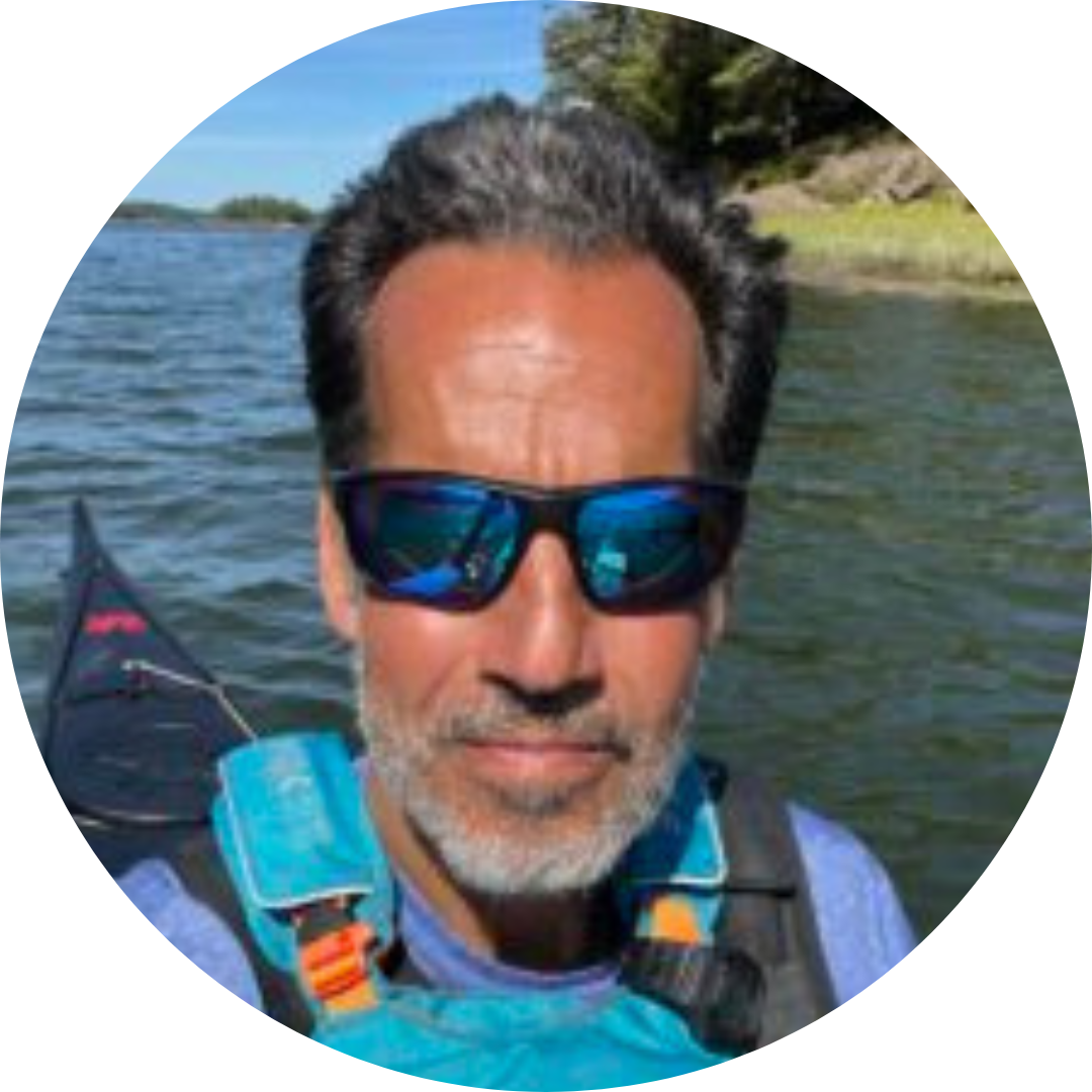 a man standing next to a body of water