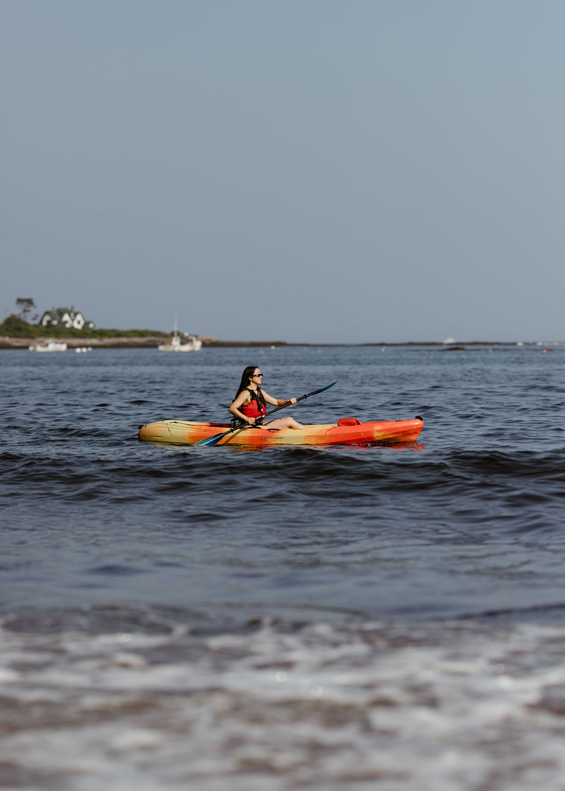 a man riding on the back of a boat in a body of water