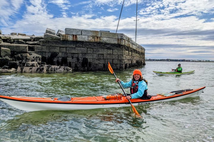a man riding on the back of a boat in the water