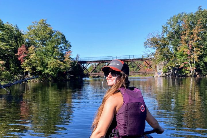 a man standing next to a body of water
