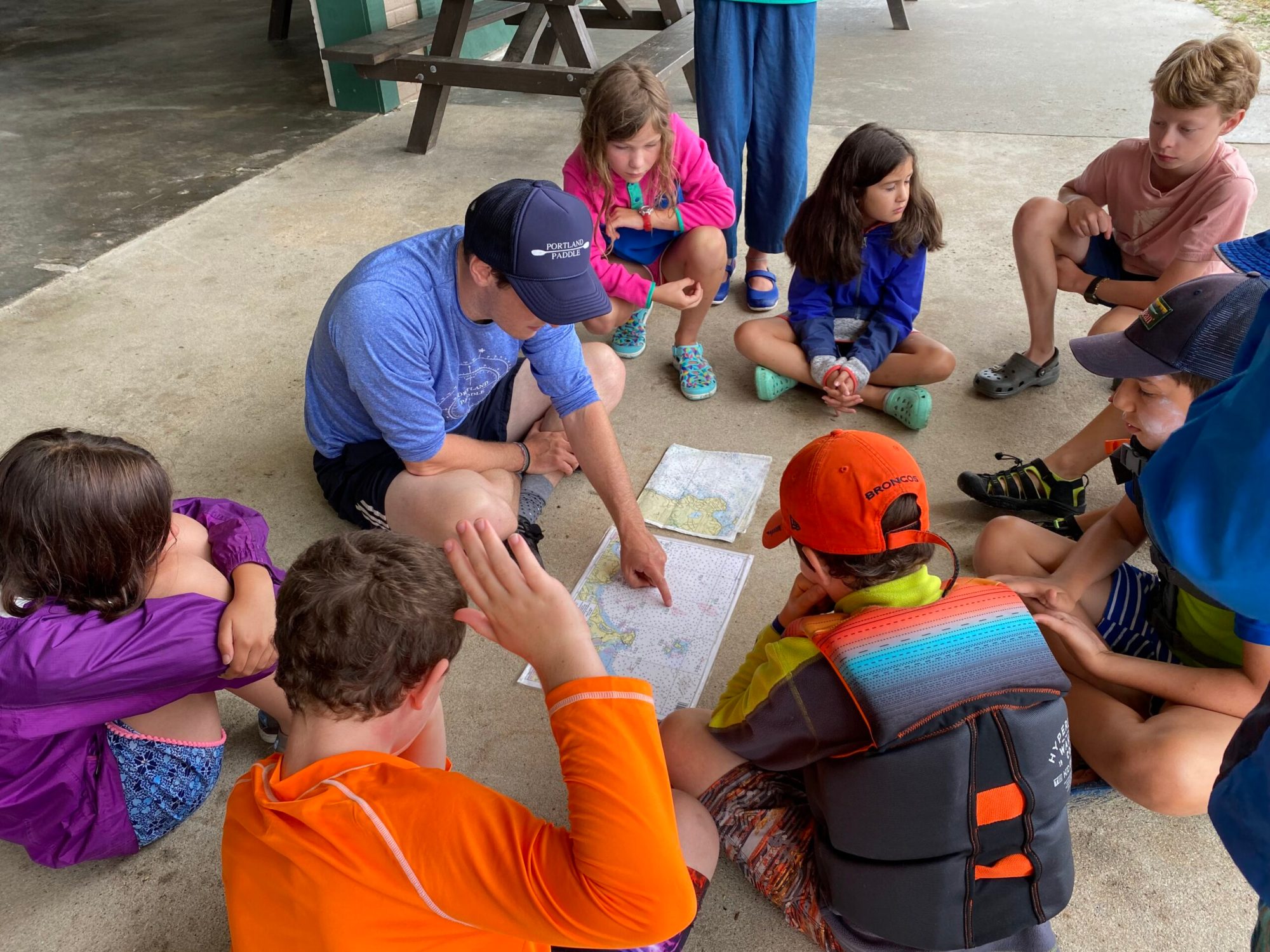 IMG_0956 Summer campers prepare to paddle by studying a map of the area