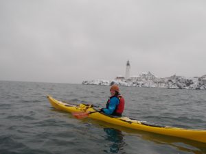 a man riding on the back of a boat in the water
