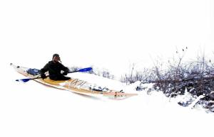 a man riding a snowboard down a snow covered slope