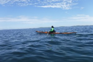 A kayaker far from land in the open ocean