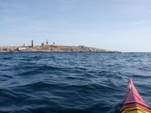 a low lying rocky island far out to sea