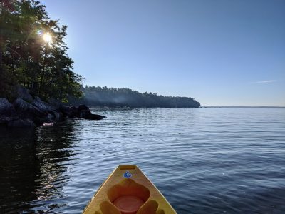 A sit on top kayak floating in a lake