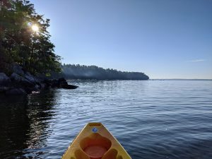A sit on top kayak floating in a lake