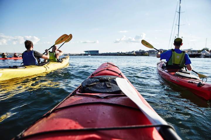 a group of people riding on the back of a boat