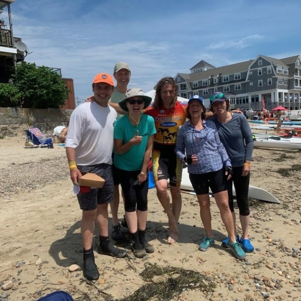 a group of people cheering for the camera after a race