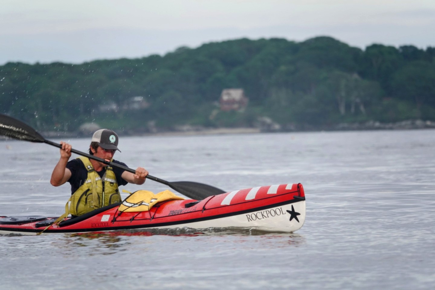 a man riding on the back of a boat in a body of water