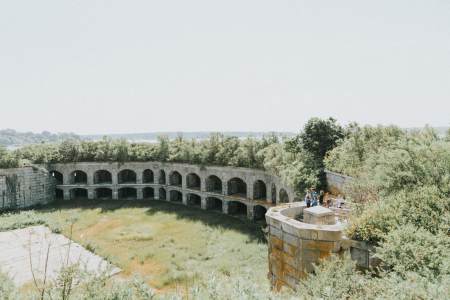 The interior of Fort Gorges, a grassy field surrounded by granite walls