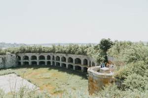 The interior of Fort Gorges, a grassy field surrounded by granite walls