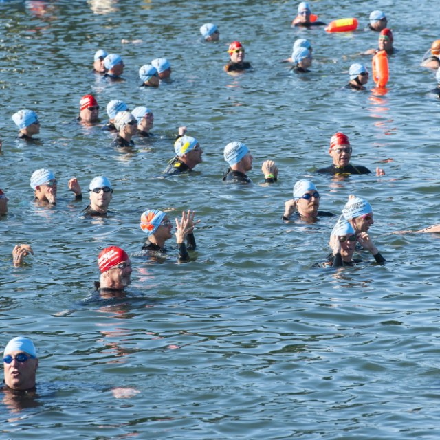 a group of people swimming in a body of water